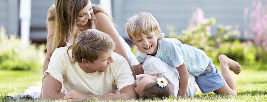 Children playing with parents in the garden