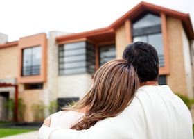 Loving couple looking at their dream house