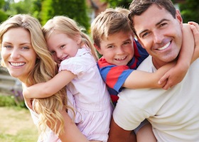 Portrait Of Happy Family In Garden