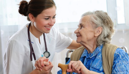 Senior woman with her doctor or caregiver