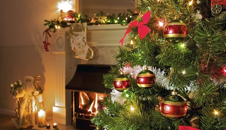 christmas tree in home living room with fireplace