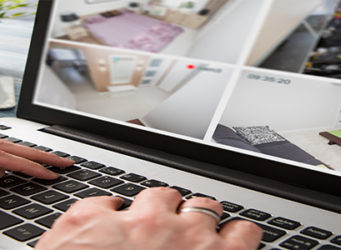 Man-monitoring-his-home-via-laptop