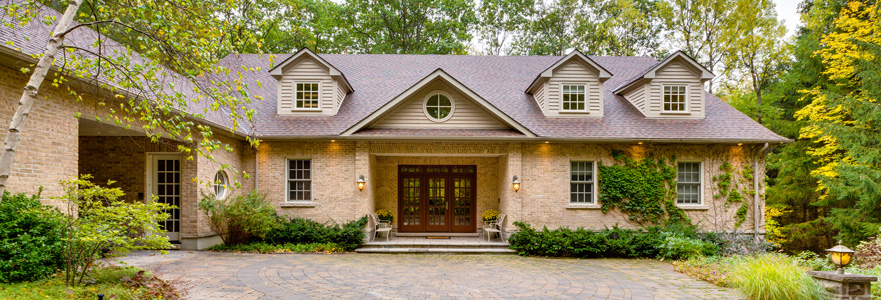 Package delivery person using a home intercom system at the front door - Moore Protection