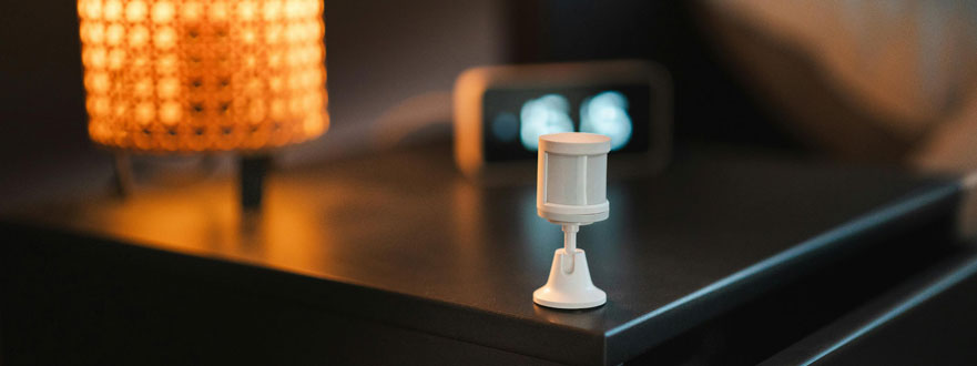 A modern motion sensor installed in a home entryway